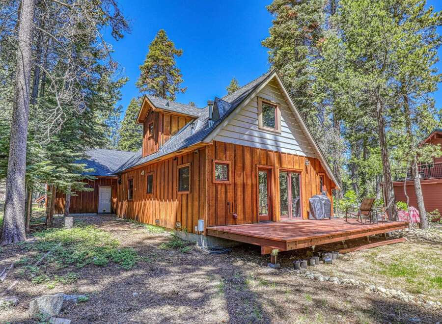 Experience mountain living in this charming wooden A-frame cabin nestled amongst tall pine trees.