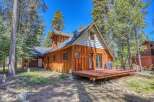 Experience mountain living in this charming wooden A-frame cabin nestled amongst tall pine trees.