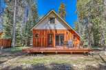 Escape to this charming cabin nestled among tall pine trees, offering a serene mountain retreat.
