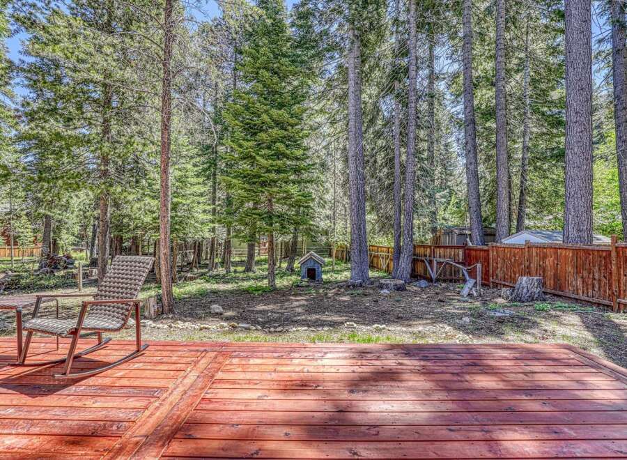 Enjoy the serene mountain lifestyle with this charming property featuring a spacious wooden deck perfect for outdoor entertaining.