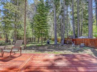 Enjoy the serene mountain lifestyle with this charming property featuring a spacious wooden deck perfect for outdoor entertaining.