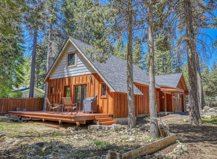 Nestled amongst tall pine trees, this charming cabin offers a serene mountain retreat.
