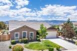 Discover this stunning home with a beautifully landscaped front yard and a spacious driveway leading to an attached garage.