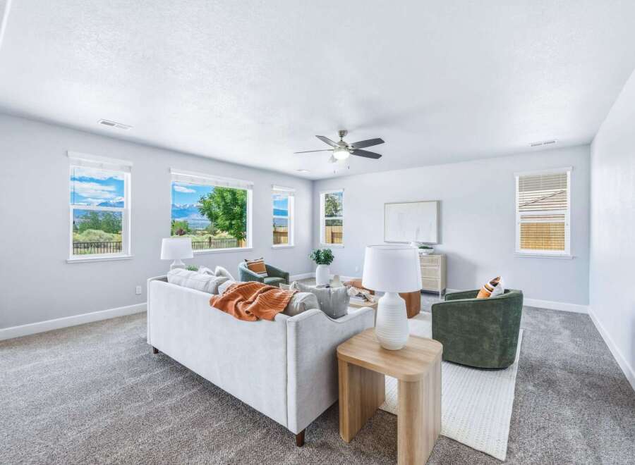 Experience breathtaking mountain views from this stunning living room, featuring large windows that flood the space with natural light.