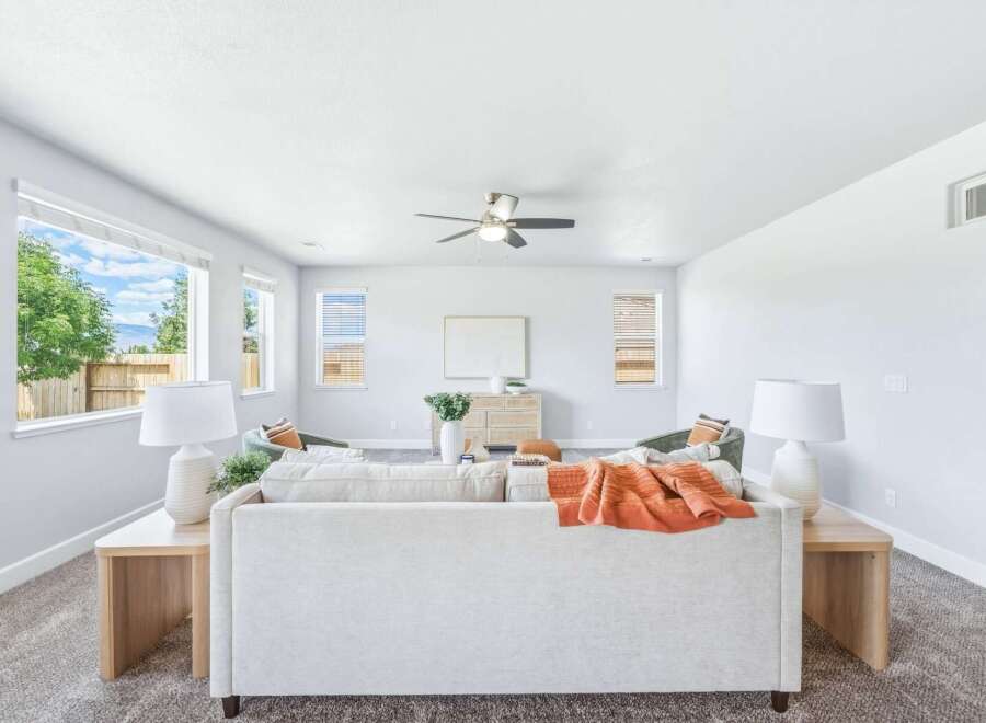 Experience modern comfort in this spacious living room, featuring a large sectional sofa perfect for gatherings.
