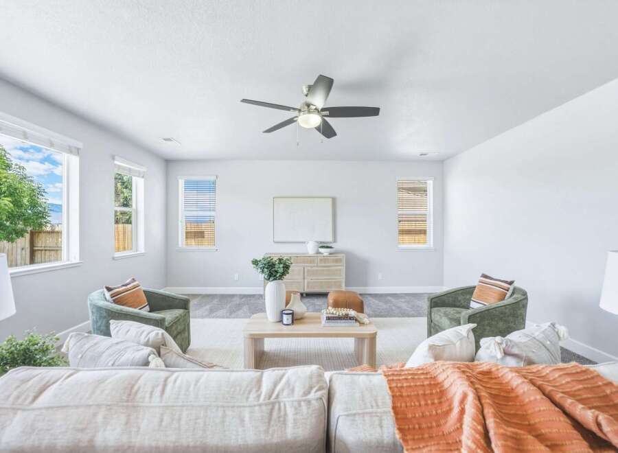 Step into this inviting living room, bathed in natural light from large windows.
