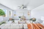 Step into this inviting living room, bathed in natural light from large windows.