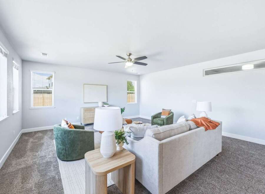 Step into this inviting living room, featuring a plush sectional sofa perfect for relaxation and a stylish armchair for added seating.
