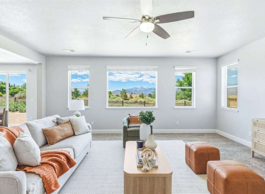 Experience breathtaking mountain views from this stunning living room, featuring a large picture window that frames the majestic landscape.