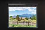 Enjoy breathtaking mountain views from this stunning property, framed perfectly by a large window.