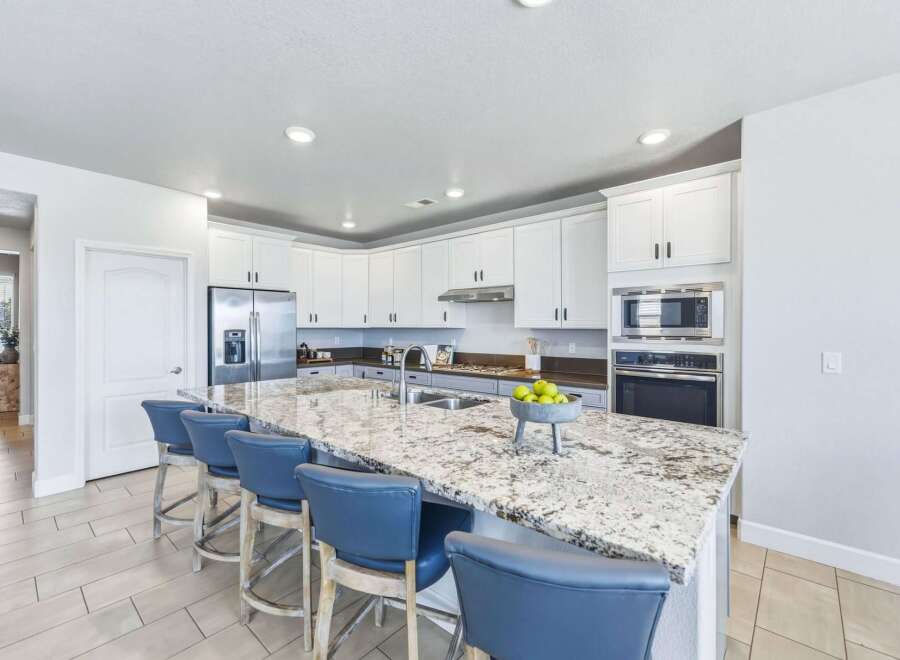 Experience culinary excellence in this stunning kitchen, featuring a spacious granite island perfect for entertaining.