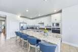 Experience culinary excellence in this stunning kitchen, featuring a spacious granite island perfect for entertaining.