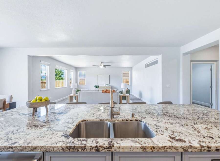 Experience modern living in this spacious open-concept home, featuring a stunning granite island with a double sink, perfect for entertaining.