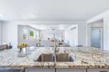 Experience modern living in this spacious open-concept home, featuring a stunning granite island with a double sink, perfect for entertaining.