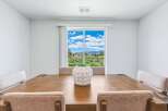 Enjoy breathtaking mountain views from this elegant dining room, featuring a large sliding glass door that floods the space with natural light.