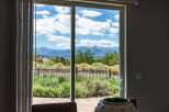Experience breathtaking mountain views from this stunning property, framed by a large sliding glass door.