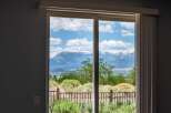Experience breathtaking mountain views from this stunning property, framed perfectly by a large sliding glass door.