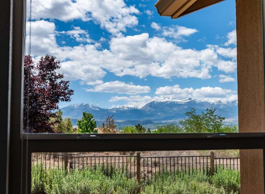 Experience breathtaking mountain views from this stunning property, framed perfectly by a large window.