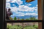 Experience breathtaking mountain views from this stunning property, framed perfectly by a large window.