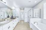 Experience luxury in this stunning master bathroom, featuring a spacious double vanity with granite countertops and ample storage.