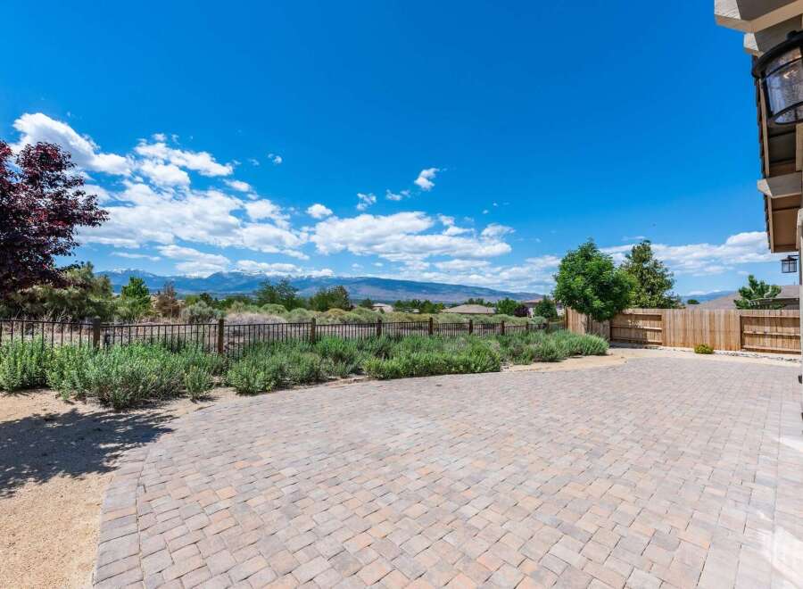Enjoy breathtaking mountain views from this expansive backyard patio, perfect for entertaining or quiet relaxation.
