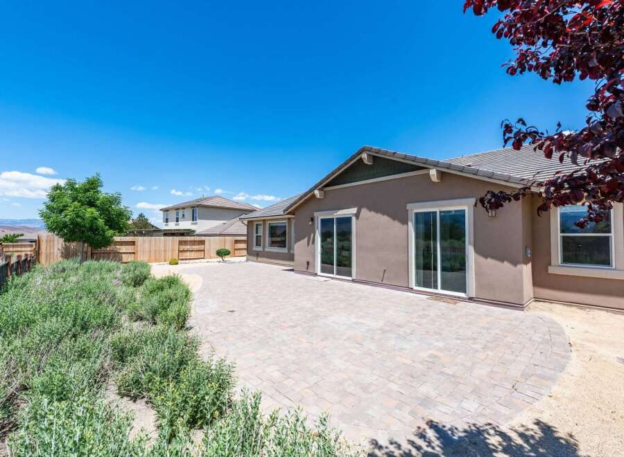 Enjoy outdoor living in this spacious backyard featuring a large paved patio perfect for entertaining.
