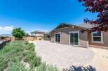 Enjoy outdoor living in this spacious backyard featuring a large paved patio perfect for entertaining.