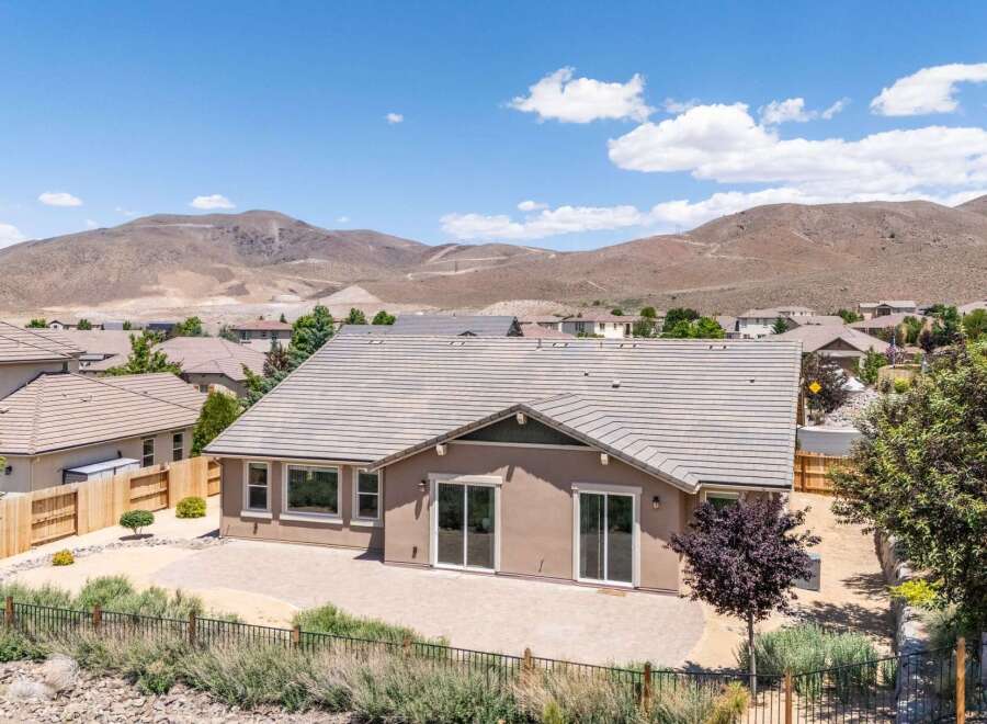 Discover this stunning home featuring a spacious backyard patio perfect for entertaining, complemented by a low-maintenance desert landscape.