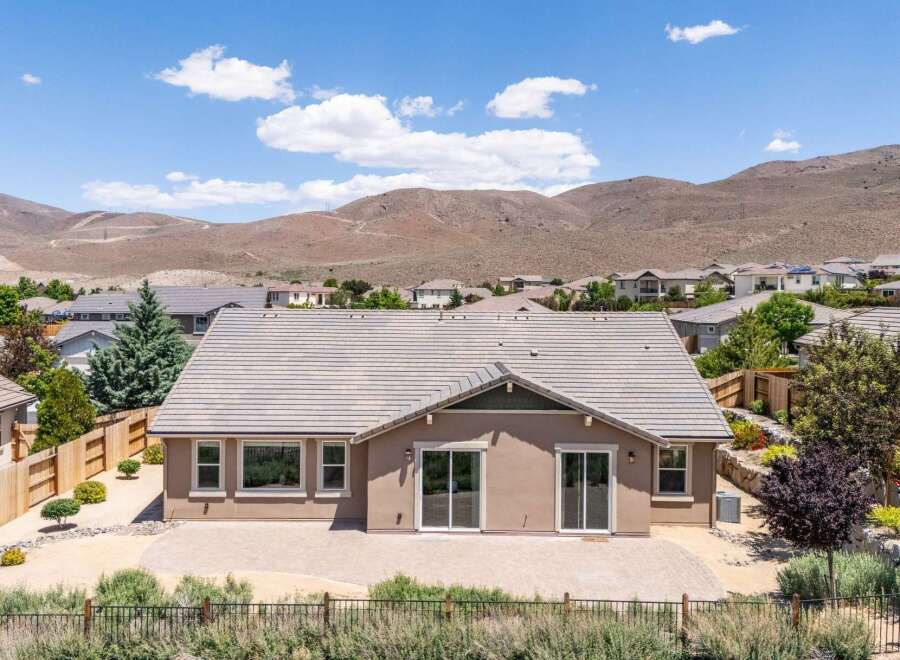Discover this charming home featuring a spacious backyard patio perfect for outdoor entertaining, complemented by a beautiful desert landscape and stunning mountain views.