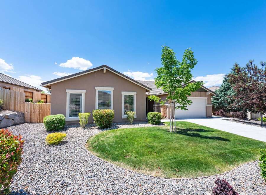 Discover this charming single-story home featuring a well-maintained lawn and attractive landscaping.