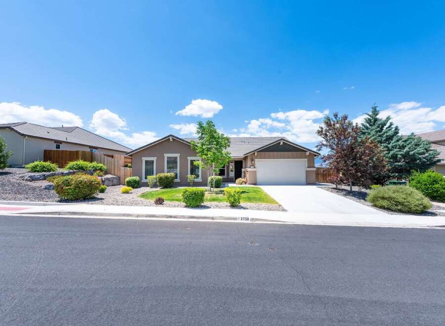 Discover this charming single-story home featuring a warm, neutral exterior and a welcoming front yard with mature landscaping.