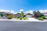 Discover this charming single-story home featuring a warm, neutral exterior and a welcoming front yard with mature landscaping.