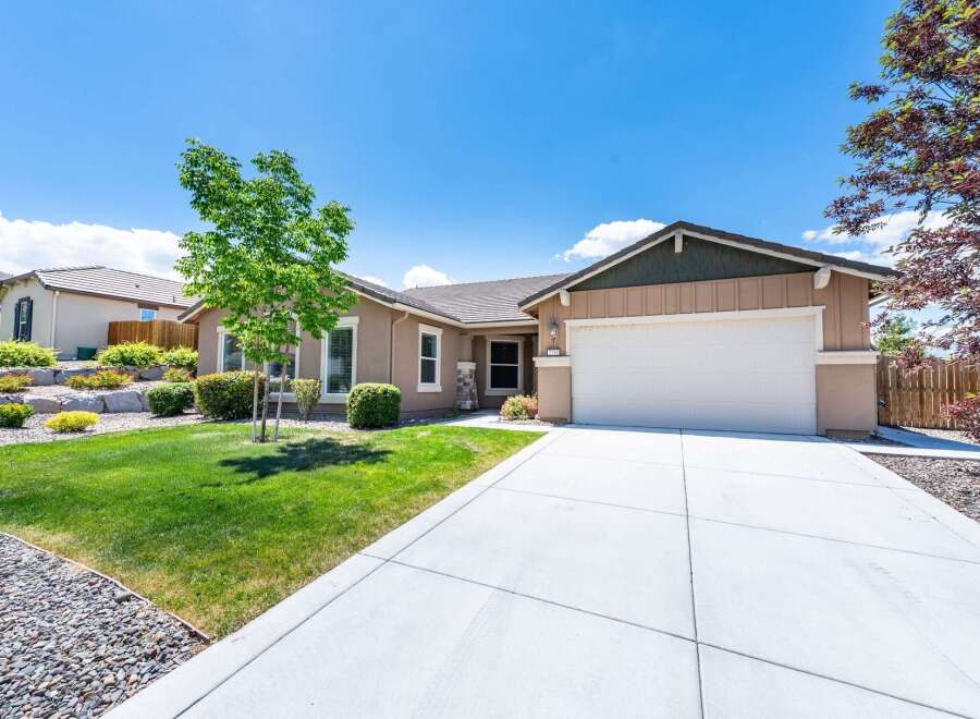 Discover this charming single-story home featuring a welcoming facade and a spacious driveway leading to an attached garage.
