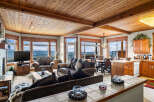 Experience breathtaking mountain views from this stunning living room, featuring a cozy fireplace and ample seating for relaxation.