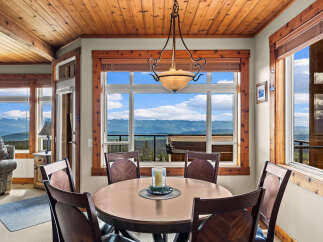 Enjoy breathtaking mountain views from this charming dining area, perfect for intimate meals or entertaining guests.