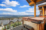 Experience breathtaking mountain views from this stunning property's private balcony, complete with a relaxing hot tub.