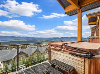 Experience breathtaking mountain views from this stunning property's private balcony, complete with a relaxing hot tub.