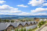 Experience breathtaking mountain views from this stunning property, nestled amidst a lush forest landscape.
