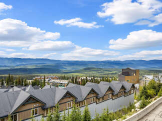Experience breathtaking mountain views from this stunning property, nestled amidst a lush forest landscape.