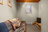Cozy living space featuring a comfortable sofa with a vibrant, patterned comforter and throw pillows.