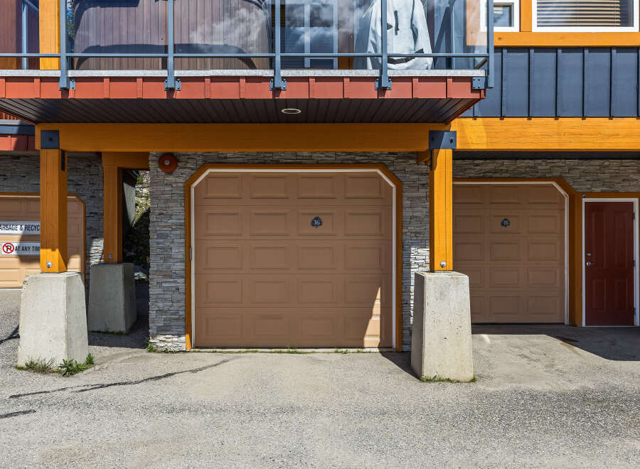 Discover modern living with this stunning property featuring multiple garage doors for ample parking and storage.