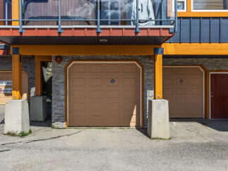 Discover modern living with this stunning property featuring multiple garage doors for ample parking and storage.