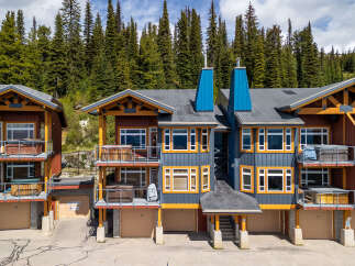 Experience luxury mountain living in this stunning property featuring multiple private hot tubs perfect for relaxation after a day of adventure.