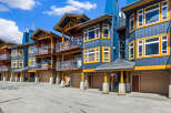 Discover modern mountain living in this stunning multi-level property featuring a striking blue and wood exterior.