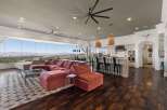 Experience breathtaking panoramic views from this stunning open-concept living space, featuring a plush sectional sofa perfect for relaxation.