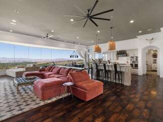 Experience breathtaking panoramic views from this stunning open-concept living space, featuring a plush sectional sofa perfect for relaxation.
