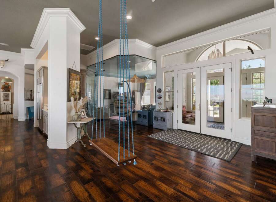 Step into this stunning home featuring a unique indoor swing, perfect for adding a playful touch to your living space.