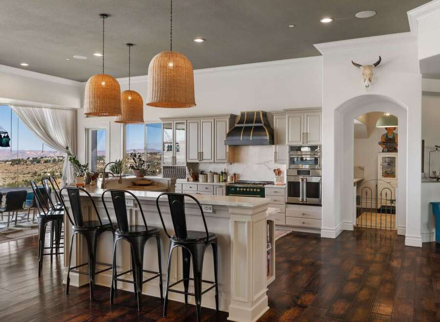 Experience breathtaking panoramic views from this stunning kitchen, featuring a large island with bar seating perfect for entertaining.