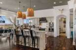 Experience breathtaking panoramic views from this stunning kitchen, featuring a large island with bar seating perfect for entertaining.