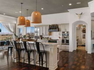 Experience breathtaking panoramic views from this stunning kitchen, featuring a large island with bar seating perfect for entertaining.